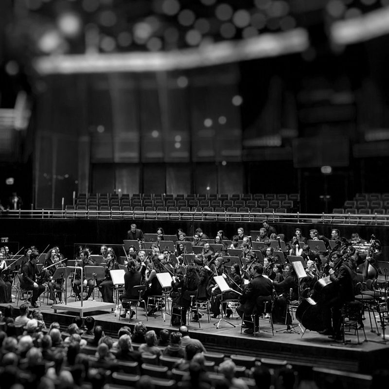 An orchestra performing on stage