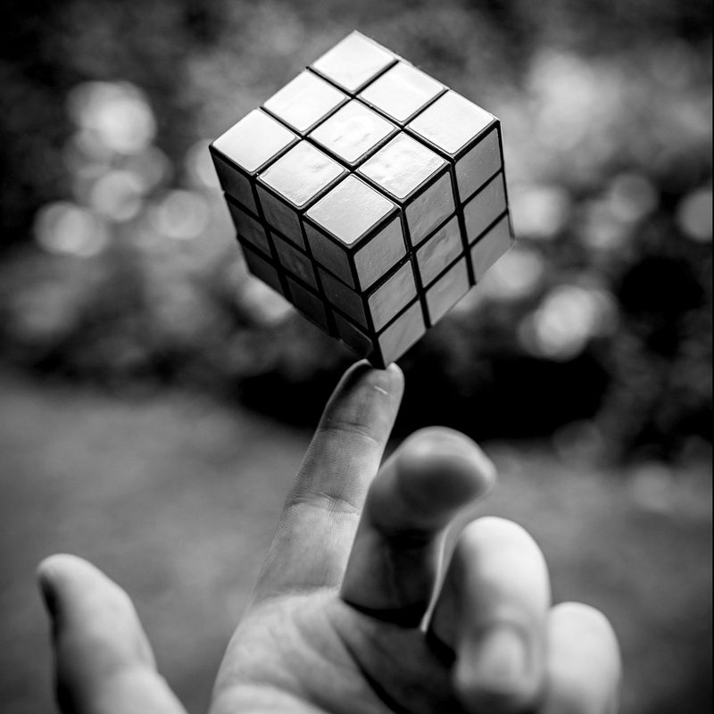 A Rubik's cube balanced on a fingertip